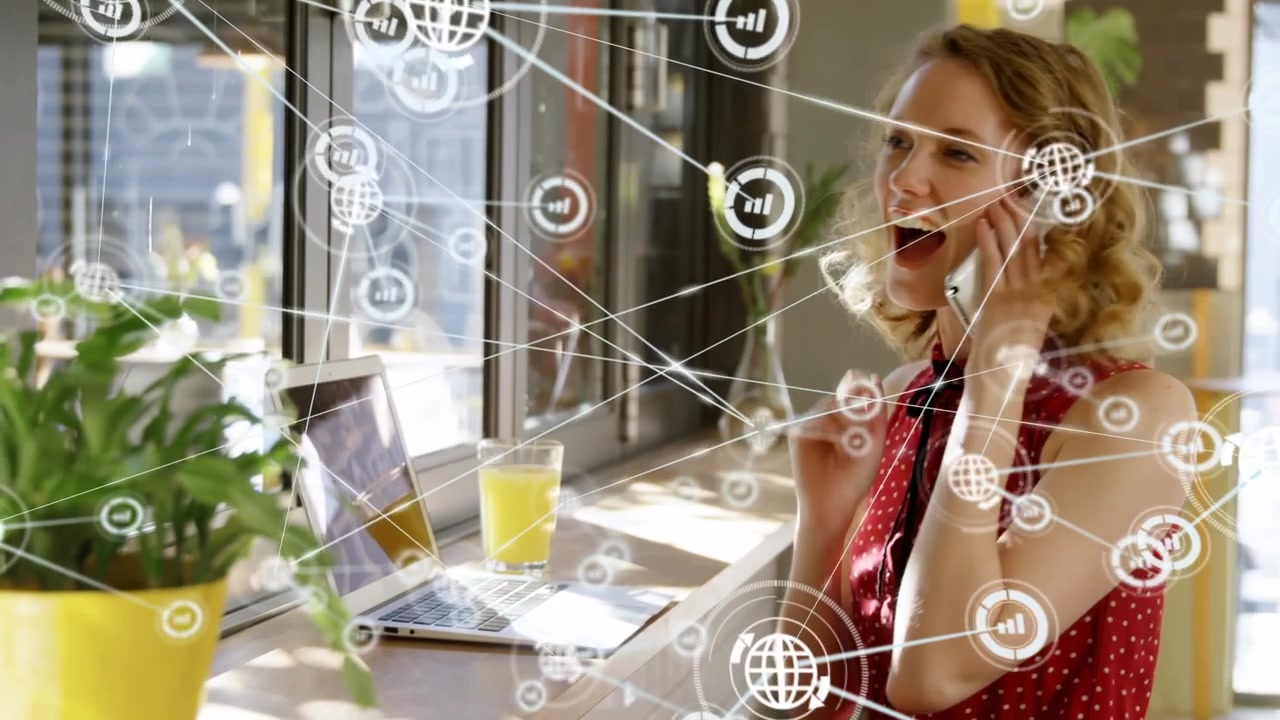 Animation of connected icons, smiling caucasian woman picking up cellphone while working in office