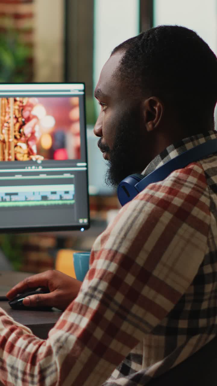 Vertical video: African american employee editing video content on multimedia software