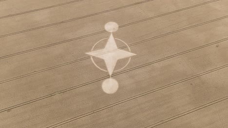 Brown-agricultural-wheat-field-with-unexplained-crop-circle