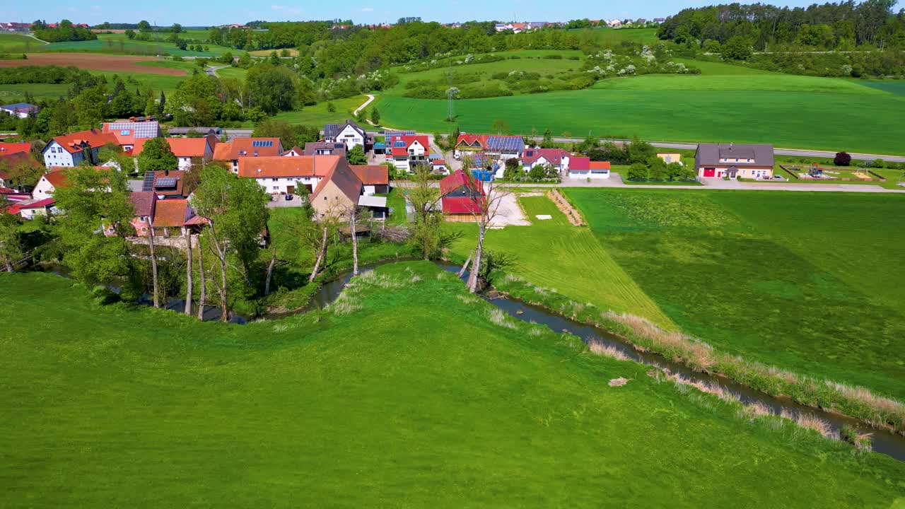 4K Aerial Drone Video of Farm Houses along the Fränkische Rezat River in the Village of Sachsen near Ansbach, Germany