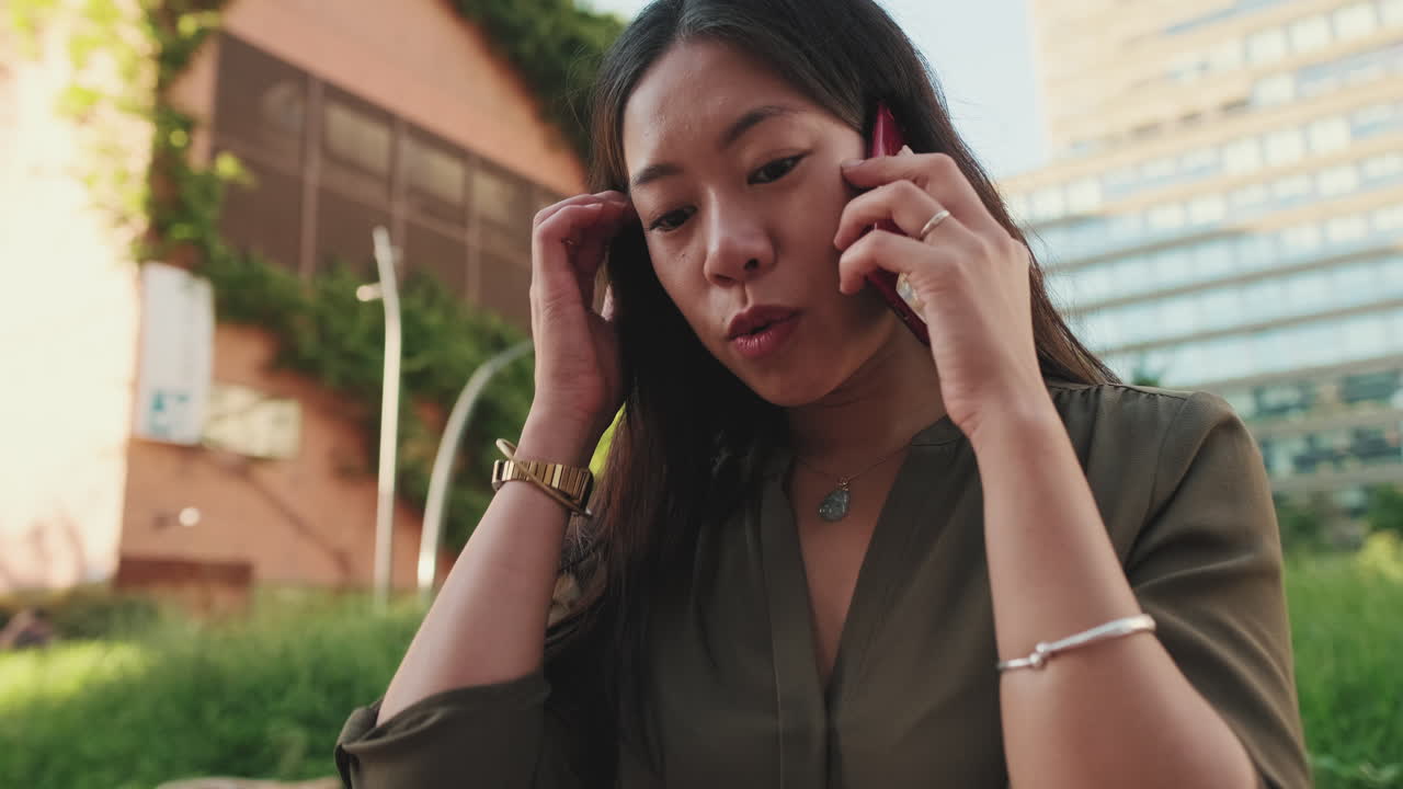 Woman talking on cell phone outdoors