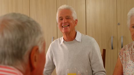 Happy-senior-man-having-meal-with-his-friends