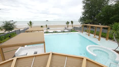 relaxing garden with the swimming pool surrounded by beautiful beach view