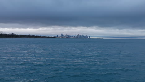 Aerial-footage-flying-close-to-the-choppy-water-of-Lake-Michigan-on-a-stormy-day-with-downtown-Chicago-in-the-background