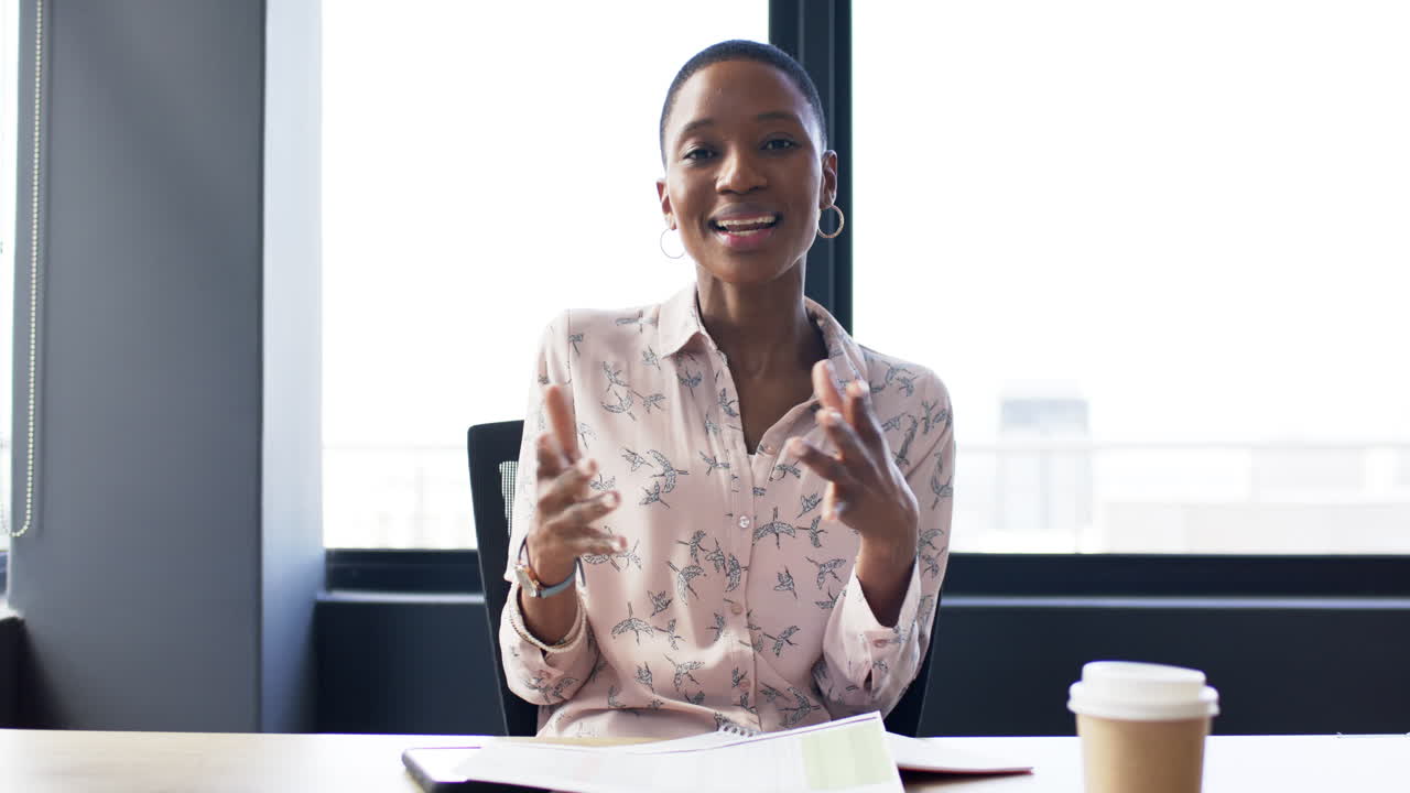 Portrait of smiling african american businesswoman in office, slow motion, copy space