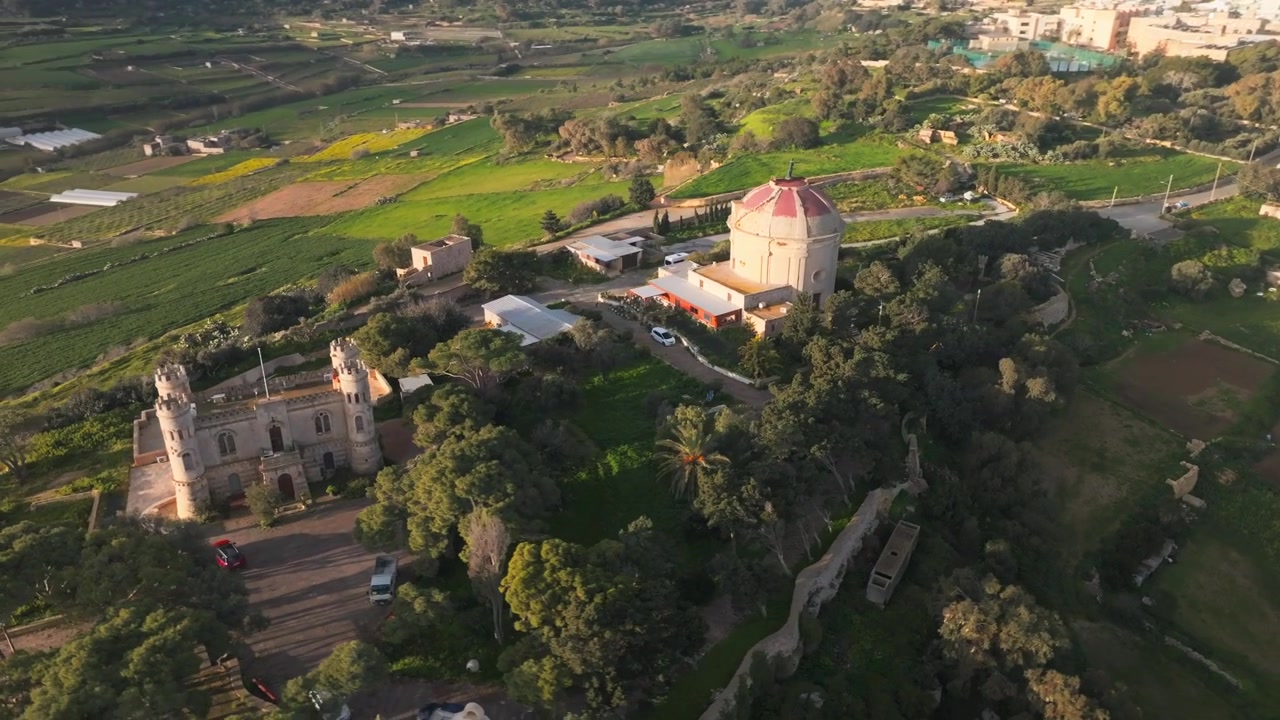 Orbita cinematografica con drone che mostra l'unica Rotonda di Tal-Virtu e l'adiacente palazzo storico a Rabat, Malta.