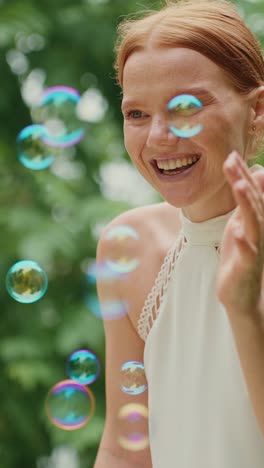 woman playing with bubbles in a garden