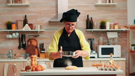 Woman-baker-using-flour-sieve