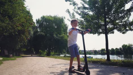 a boy rides a scooter in a city park 16