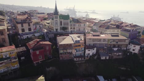 Aerial-View-Of-Valparaiso-Lutheran-Church-On-Bright-Sunny-Day-With-Valparaiso-bay-In-background