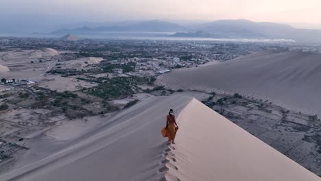 Woman-walking-by-sand-dune