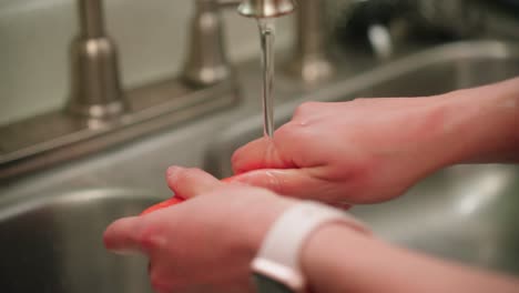 hand washing carrot in the sink