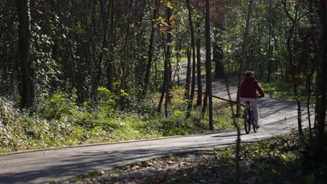 riding bicycle on winding path autumn trees outdoor sport leisure in serene park