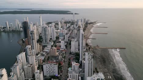 aerial along the playa de bocagrande beaches and skyscrapers at dusk in cartagena, boliviar, colombia