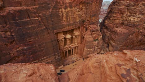 the treasury khaznet at petra, historic unesco heritage site carved into sandstone in jordan seen from a viewpoint above