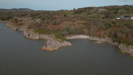 secluded gravel beach pull away revealing rugged english winter coastline at jenny brown's point uk