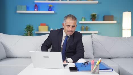 home office worker man looking at camera depressed.