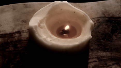 candle placed on wood slowly moving dancing in the night