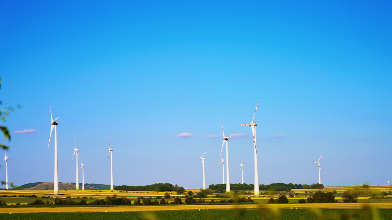 Picturesque countryside with wind farms. Green energy generation in the fields.