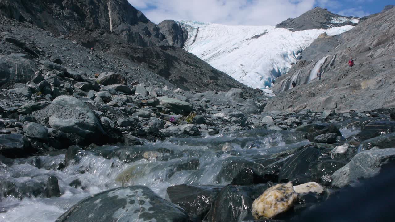 Alaskan Glacier Melts and Pours onto Rocks, Forming a Small River