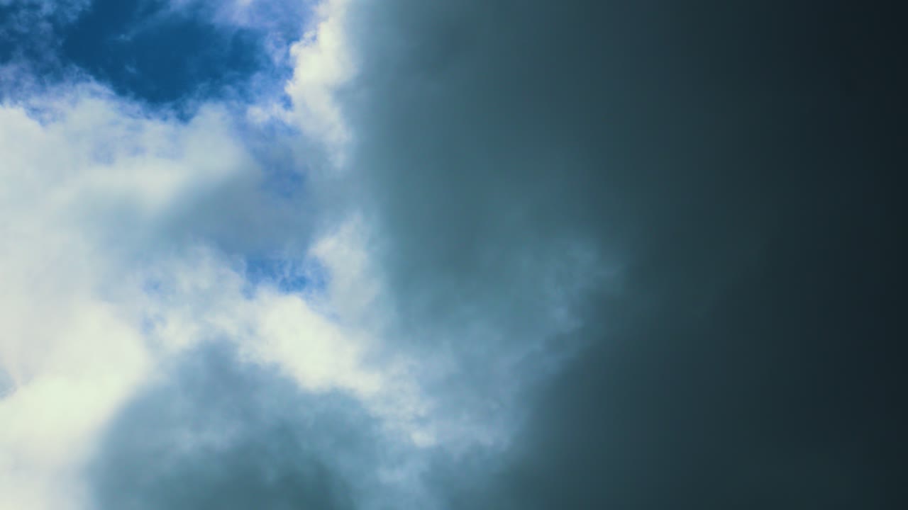 Contrasting Clouds Timelapse of Storm Moving in Over Bright Blue Sunlit Sky. Natural Background Wallpaper Time Lapse.
