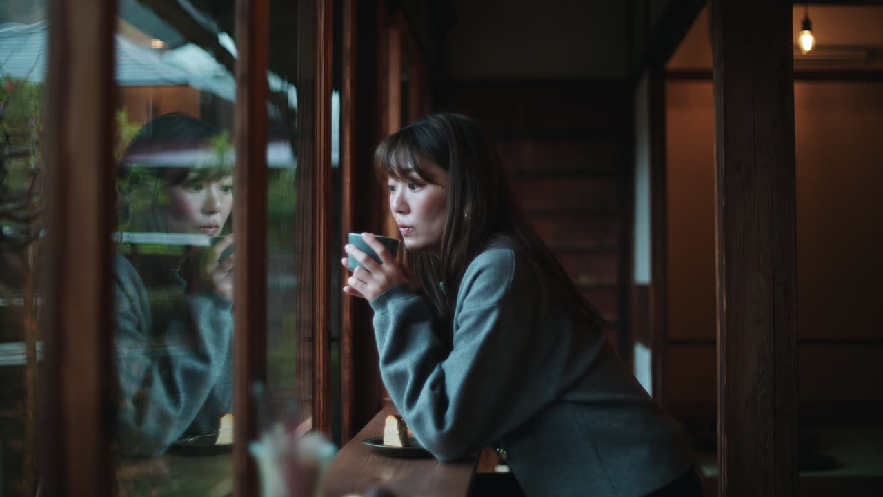 Woman in Cafe Looking Out Window