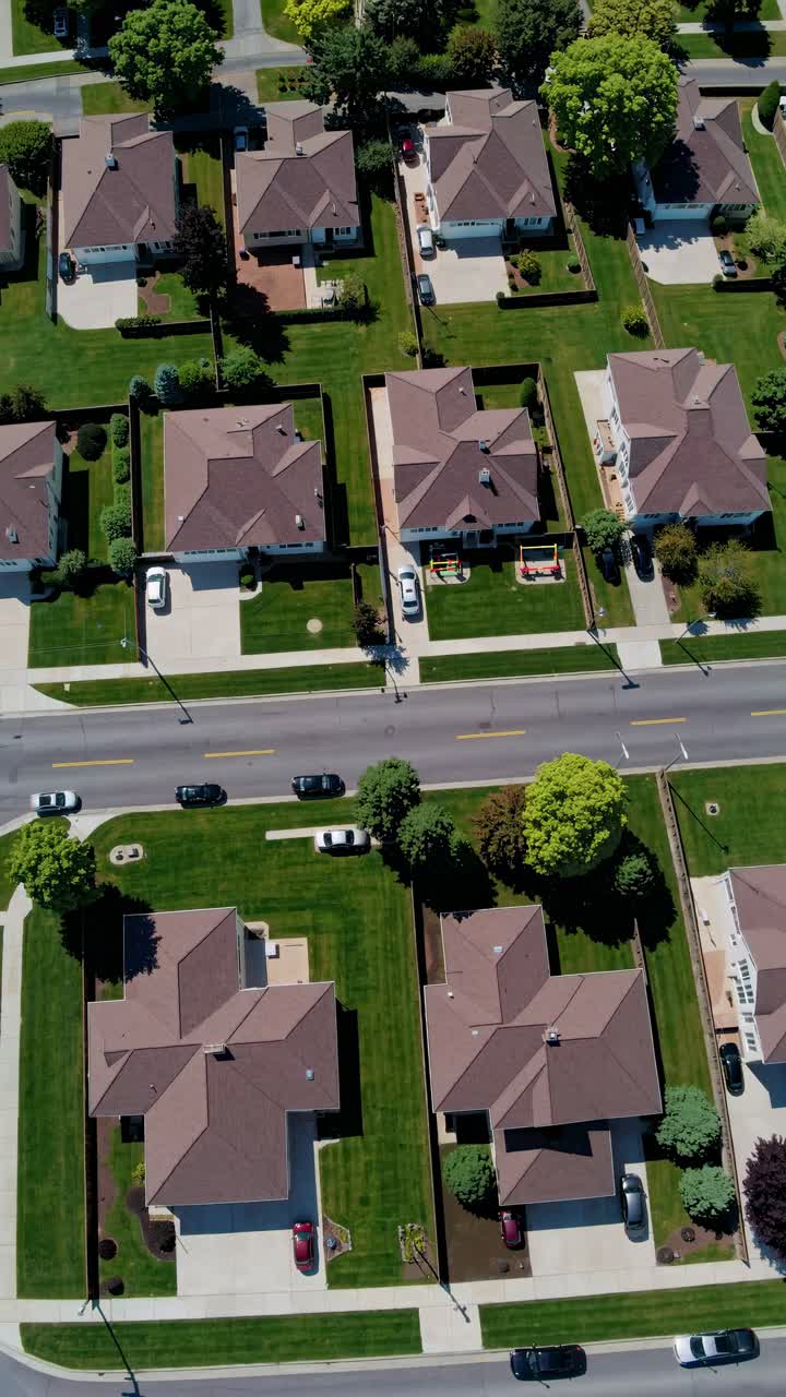 Aerial view of suburban neighborhood with neatly arranged houses and lawns