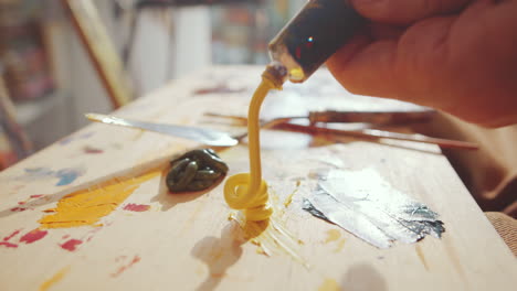 Squeezing-Paint-from-Tube-on-Wooden-Palette