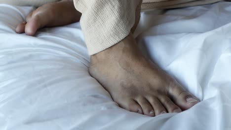 close up of a person's feet on a white bed sheet