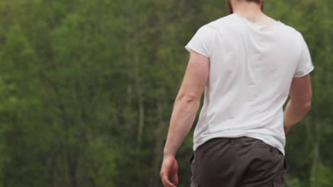 defocus nature with a man showing muscles is holding an axe