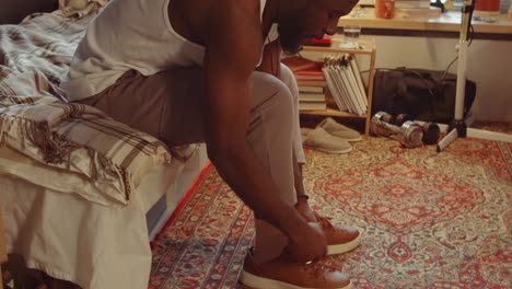 african american man getting dressed at home