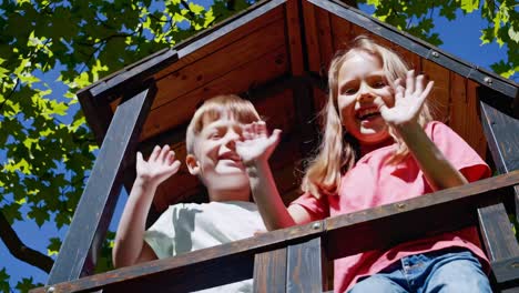 happy children playing in a treehouse