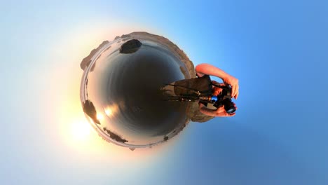 vertical shot of a photographer filming bandon beach