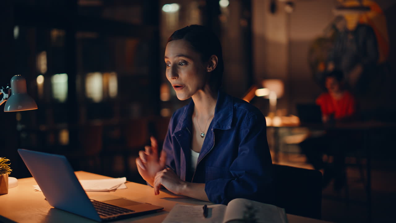 Happy freelancer video calling at night coworking closeup. Smiling businesswoman