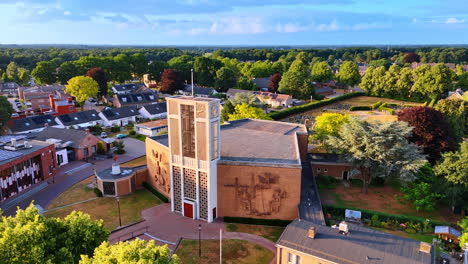 unusual building of a church with bells tower over the entrance. picturesque green panorama of overloon, netherlands. aerial view