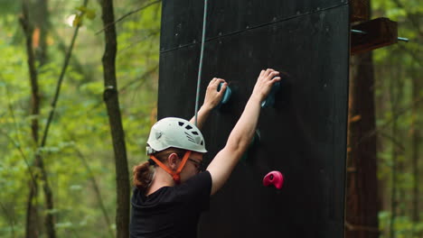 Person-climbing-wall-outdoors