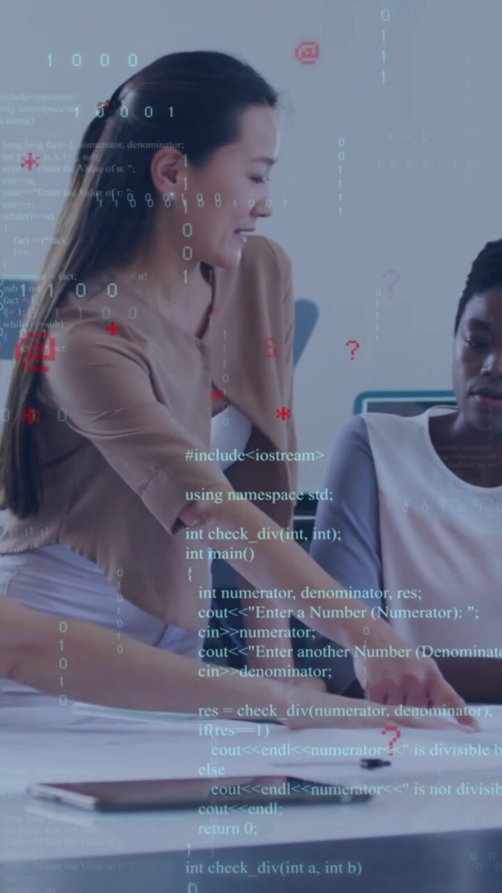 Vertical video: Lead leaning over table, pointing to docs, tablet, code overlay guiding tech review