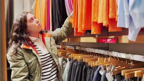 young woman choosing clothes in a retail store