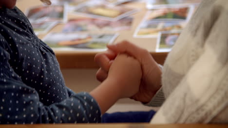 Mother-And-Daughter-Playing-Game-With-Hands-At-Home-Together