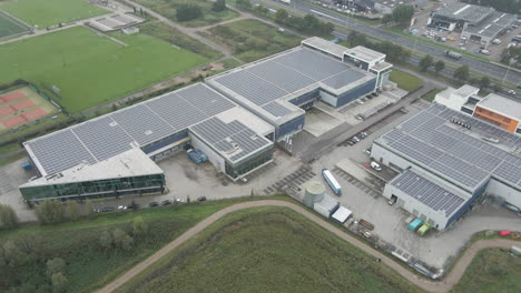 aerial view of busy industrial terrain with solar panels on rooftop