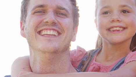 portrait of smiling family outdoors in summer park