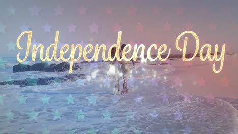 Animation-of-independence-day-text-with-american-flag-pattern-over-couple-in-love-on-beach