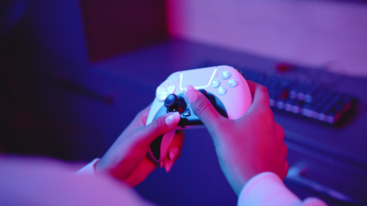 Playing video game, woman holding controller with keyboard in background