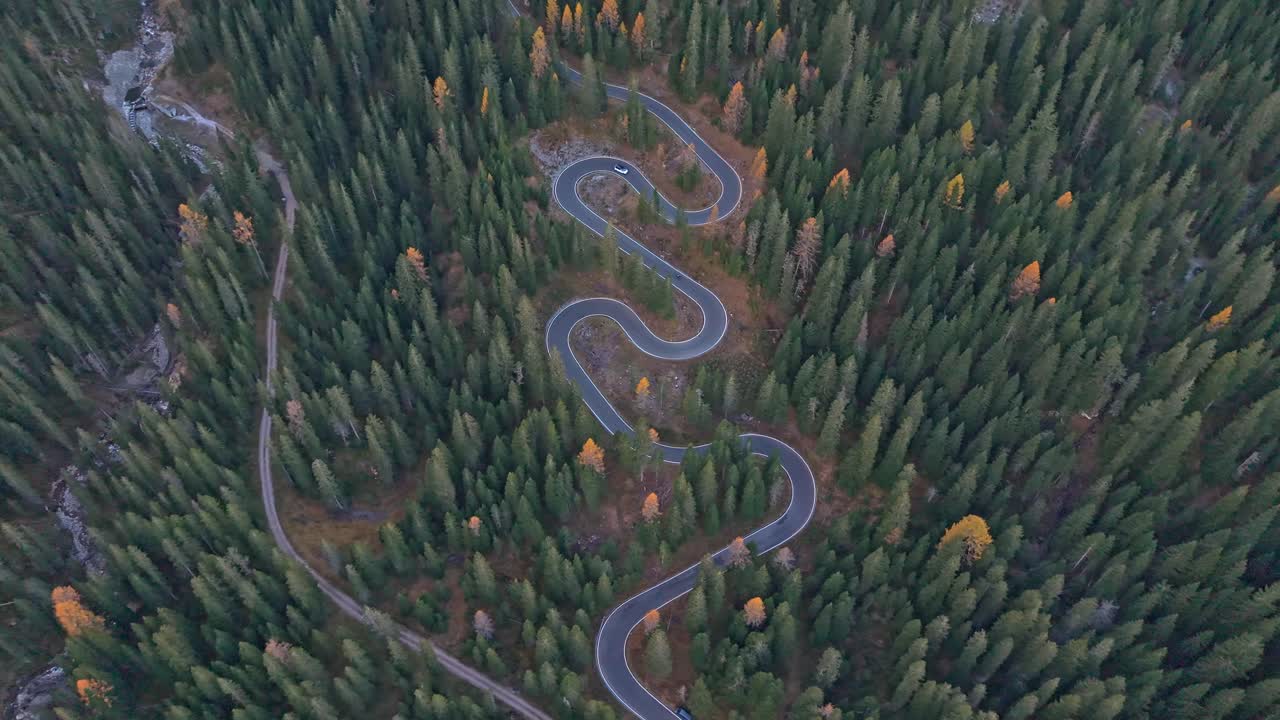Scenic aerial of winding mountain road in the heart of the Dolomites