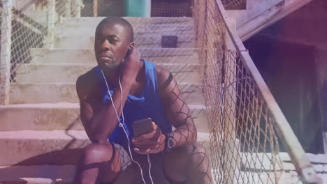 man adjusting earbud on concrete steps, showing animated smartphone data and fitness chart overlays