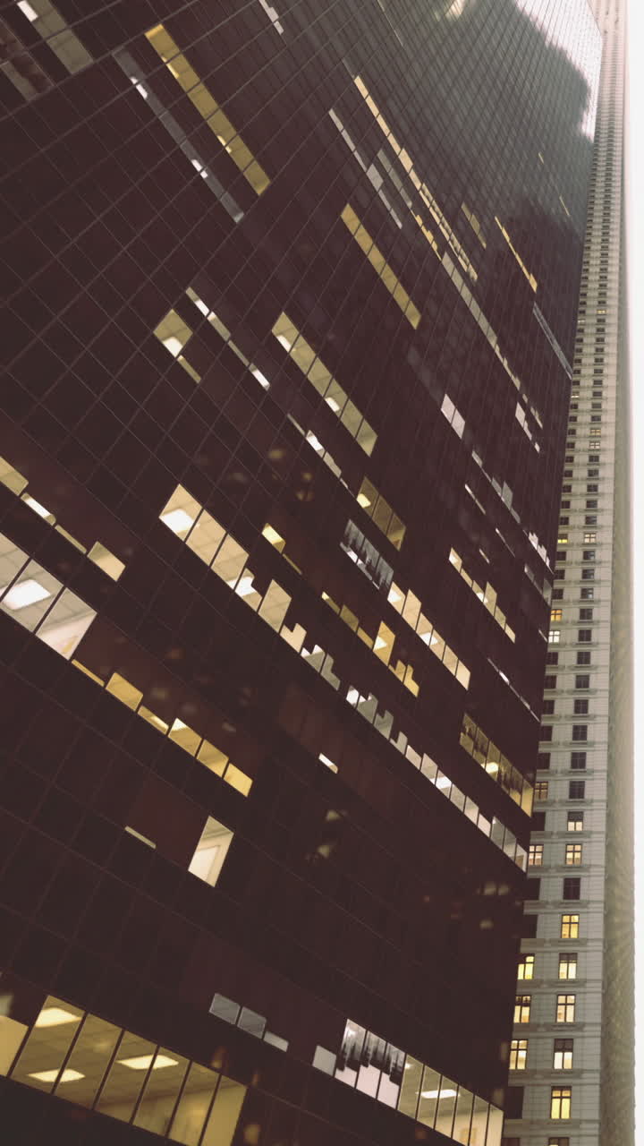 Urban reflections on a modern skyscrapers glass facade at dusk