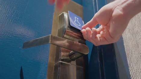 Person using electronic keycard for opening door at modern hotel