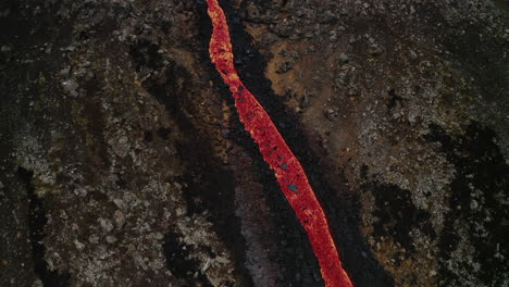 scenic tilt up of natthagi volcano lava stream running down hill