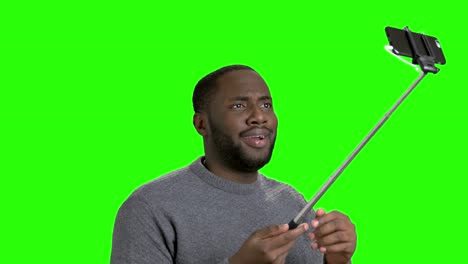 african american man using monopod.