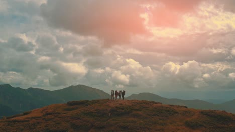 the group of tourists standing on the mountain top